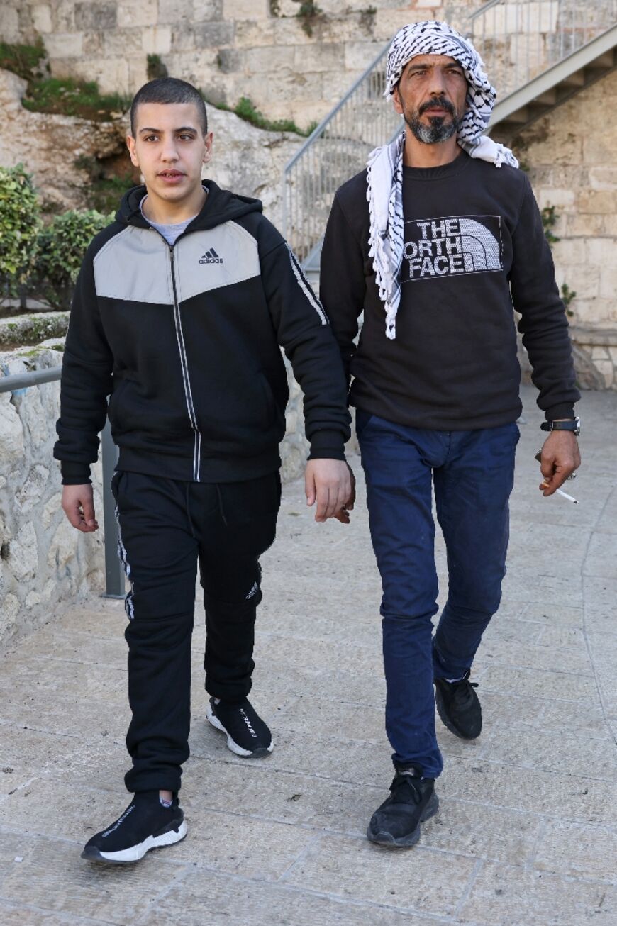 Ahmed al-Salaymeh, 14, with his father Nayef, (R), who says the ministry decision would lead to 'young people in the streets with no future'