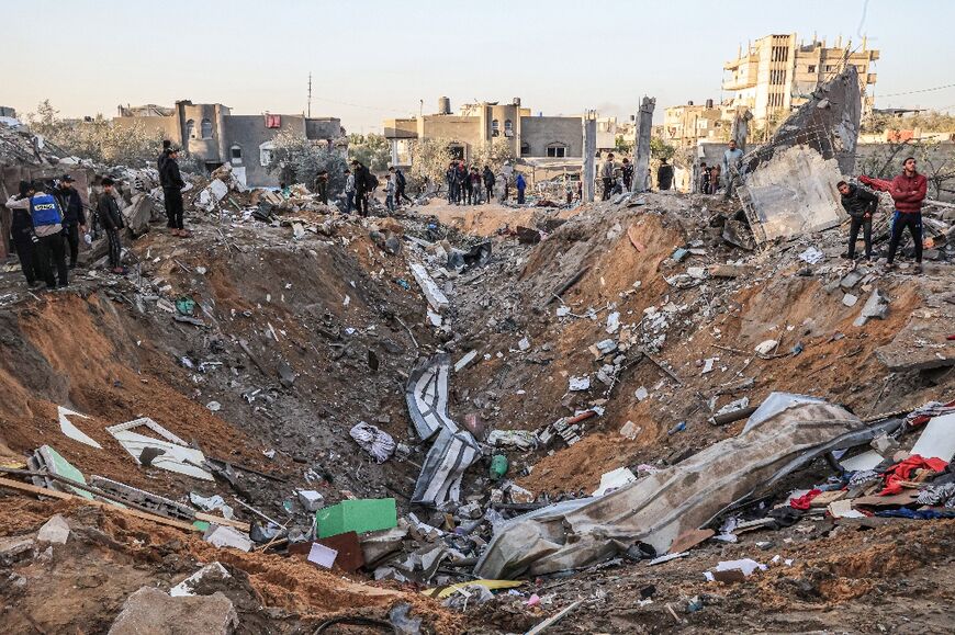 People search the rubble after an Israeli strike in Rafah on December 12