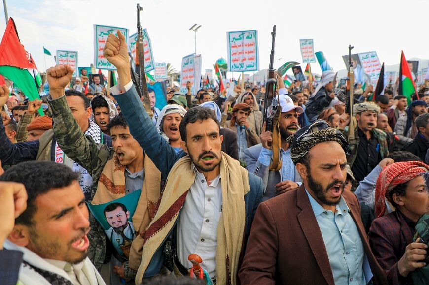 Yemenis brandish their guns during a march in solidarity with the people of Gaza, in the Huthi-controlled capital Sanaa on December 15, 2023
