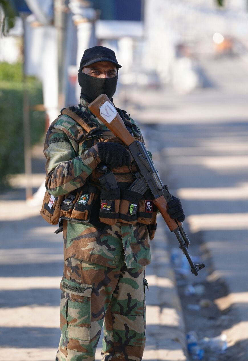 A member of the Iraqi security forces stands guard at a polling station in the central city of Najaf