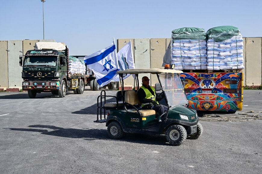 Trucks arriving from Egypt with humanitarian aid await inspection on the Israeli side of the Kerem Shalom border crossing with the southern Gaza Strip 