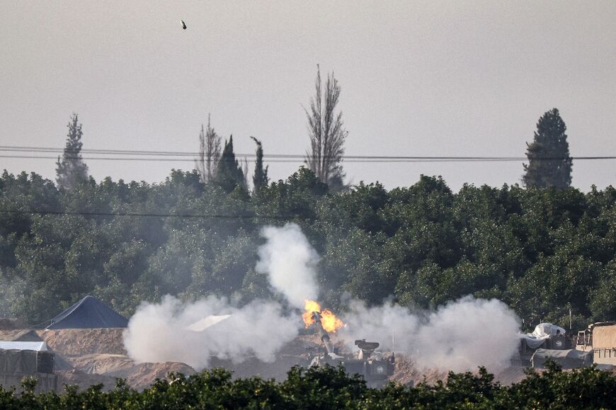 An Israeli tank fires towards the Gaza Strip, from the border area with Israel