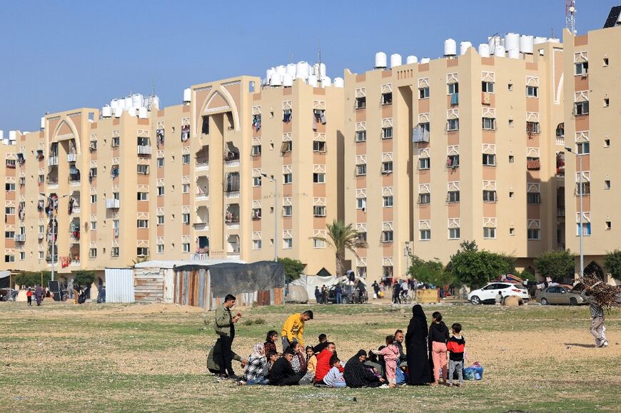 Residents of the Qatari-funded Hamad City residential complex in the Gaza Strip gather belongings  after receiving notification from the Israeli army of an imminent strike
