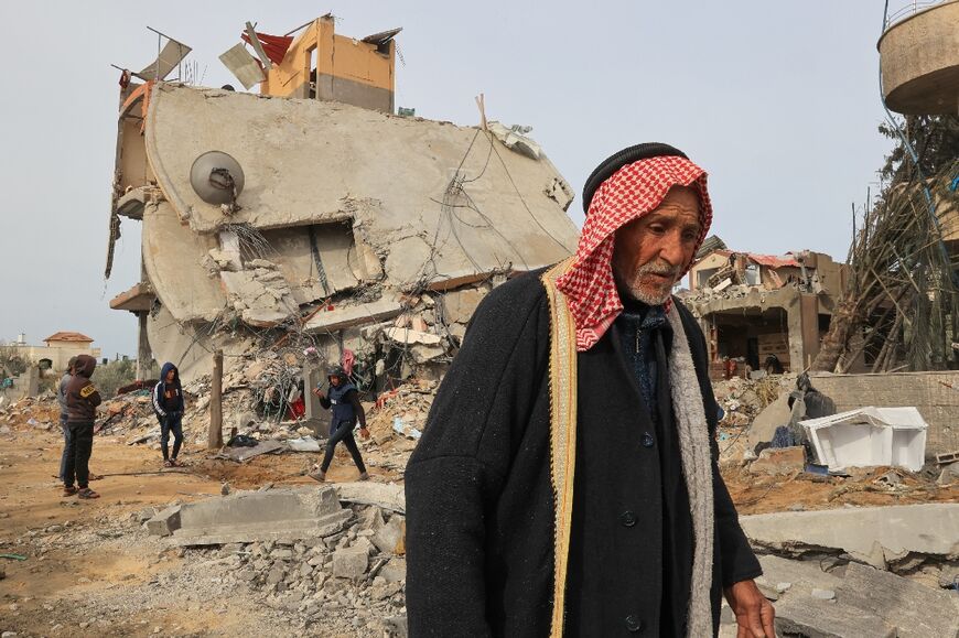 Palestinians check the rubble following Israeli bombardment in Khan Yunis, the southern Gaza Strip