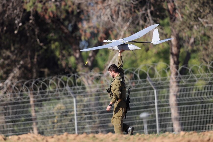 An Israeli soldier prepares to launch a drone along the border with Gaza