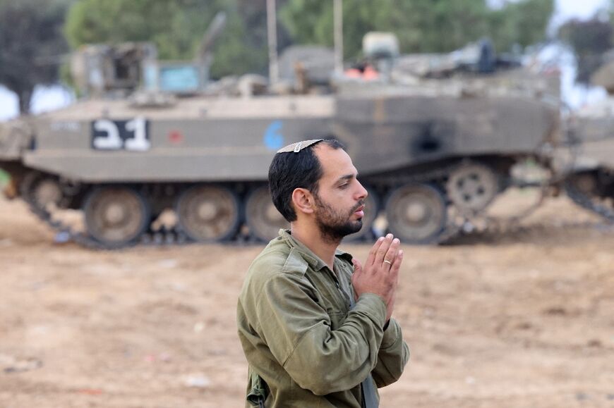 An Israeli soldier prays  near the Gaza border 