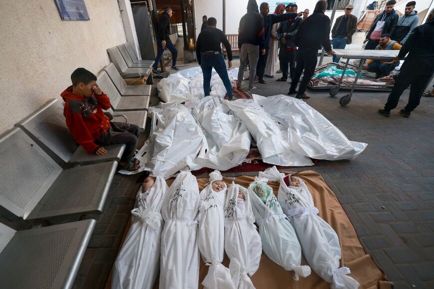 People mourn people killed following Israeli bombardment at al-Najjar hospital in Rafah in the southern Gaza Strip on December 12, 2023