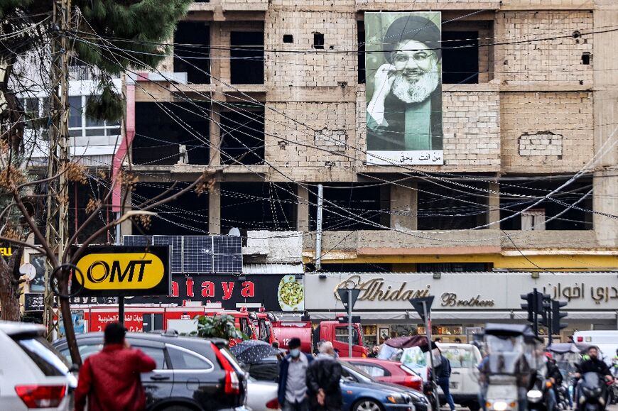 A picture of Hezbollah leader Hassan Nasrallah hangs on a Beirut building near the site of the strike that killed Hamas deputy leader Saleh al-Aruri 