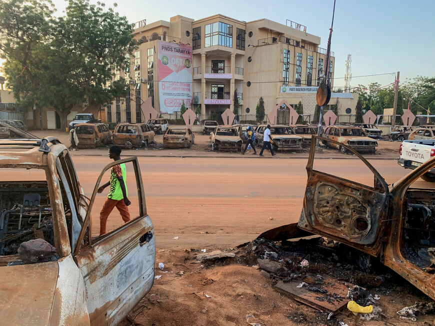 Burned cars are seen in front of the headquarters of the Nigerien Party for Democracy and Socialism of Niger's ousted president Mohamed Bazoum in Niamey on September 19, 2023. (Photo by AFP) (Photo by -/AFP via Getty Images)