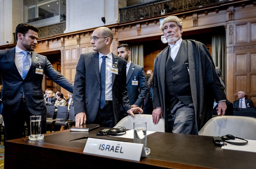 Israel Deputy Attorney-General for International Affairs Gilad Noam (C) and lawyer Malcolm Shaw (R) arrive at the International Court of Justice (ICJ) prior to the verdict announcement in the genocide case against Israel, brought by South Africa, in The Hague on January 26, 2024. (Photo by Remko de Waal / ANP / AFP) / Netherlands OUT (Photo by REMKO DE WAAL/ANP/AFP via Getty Images)