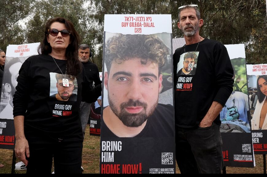 Ilan Gilboa Dala and his wife Merav stand next to a portrait of their son Guy Gilboa Dalal who taken hostage by Palestinian militants at the Nova festival 