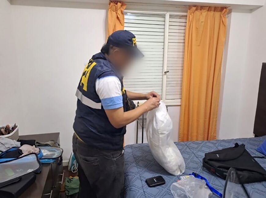 Argentine Federal Police search a room after an operation in which three people were arrested over an alleged "terrorism" plot