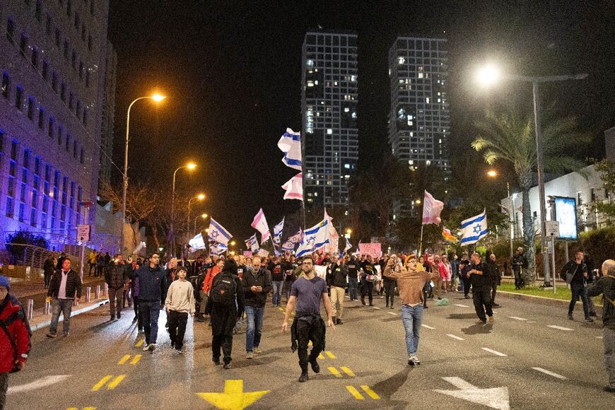 Israeli anti-war protesters march in Tel Aviv on the sidelines of a rally organised by the families of hostages held in Gaza