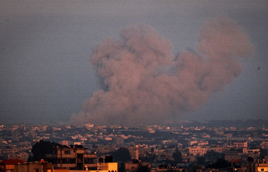 Seen from Rafah, smoke billows over Khan Yunis city, the southern Gaza Strip, during Israeli bombardment