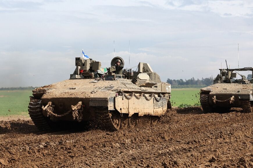 Israel tanks move along the border with Gaza where fighting with Hamas militants continues to rage 