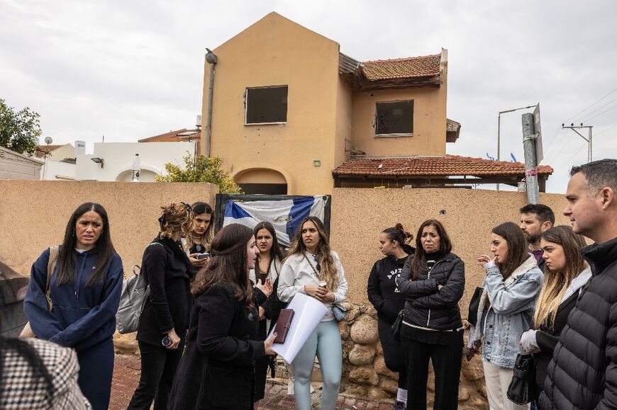 Israelis visit a site in Ofakim, a town in southern Israel, some 25 kilometres (15 miles) from the Gaza Strip, which was targeted in the October 7 attack 
