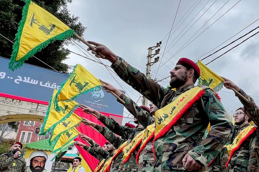 Hezbollah fighters parade during a ceremony in the Lebanese village of Jibshit