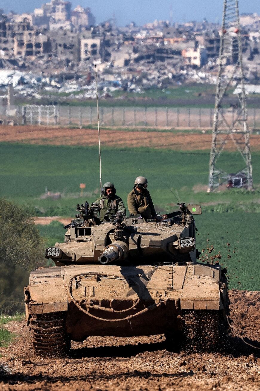 An Israeli battle tank moves along the border between southern Israel and the Gaza Strip on January 31, 2024