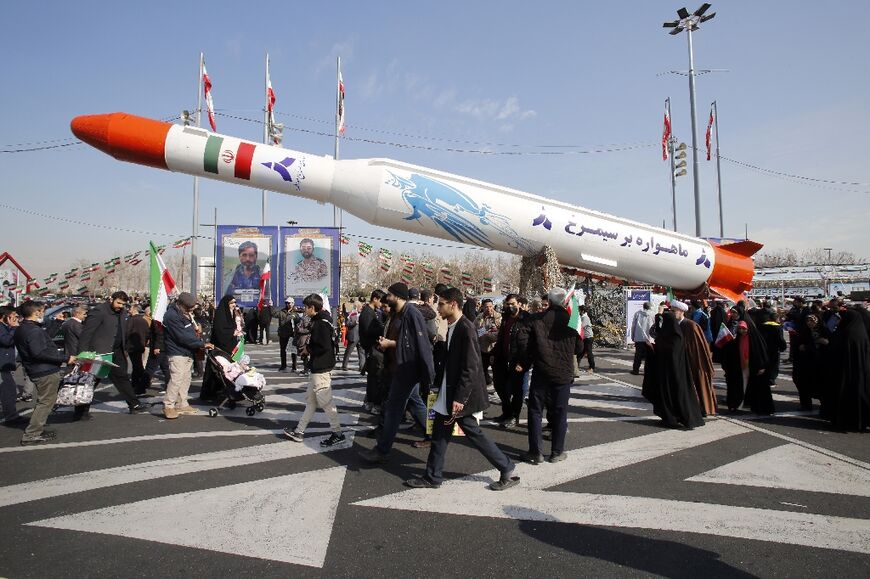 Iran's two-stage Simorgh (Phoenix) satellite carrier is displayed in Tehran as people gather to mark the 45th anniversary of the Islamic revolution
