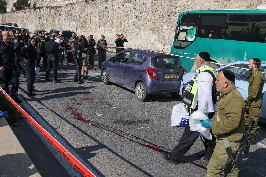 Israeli security forces and rescue teams inspect the scene of the attack 