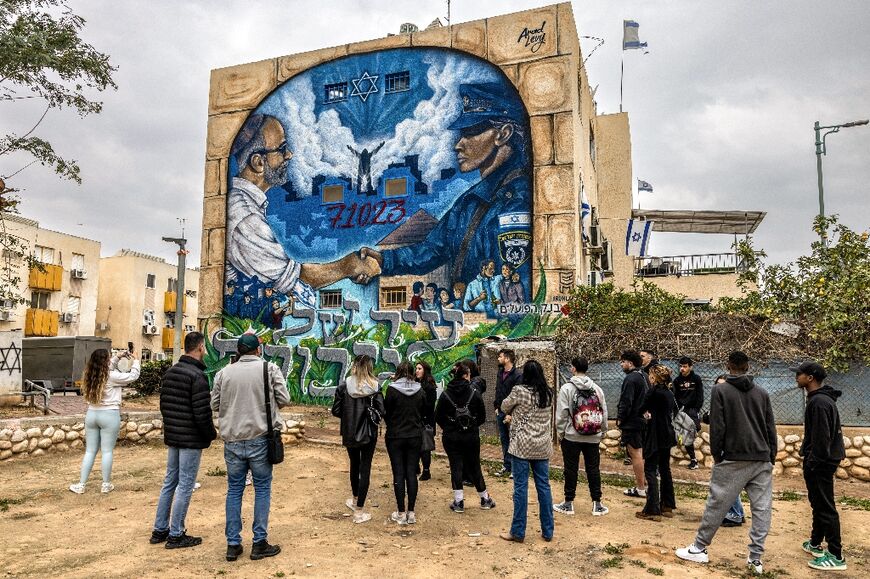 On the edge of the neighbourhood, a huge mural has been painted of a female police officer shaking a civilian's hand above the slogan 'city of heroes'