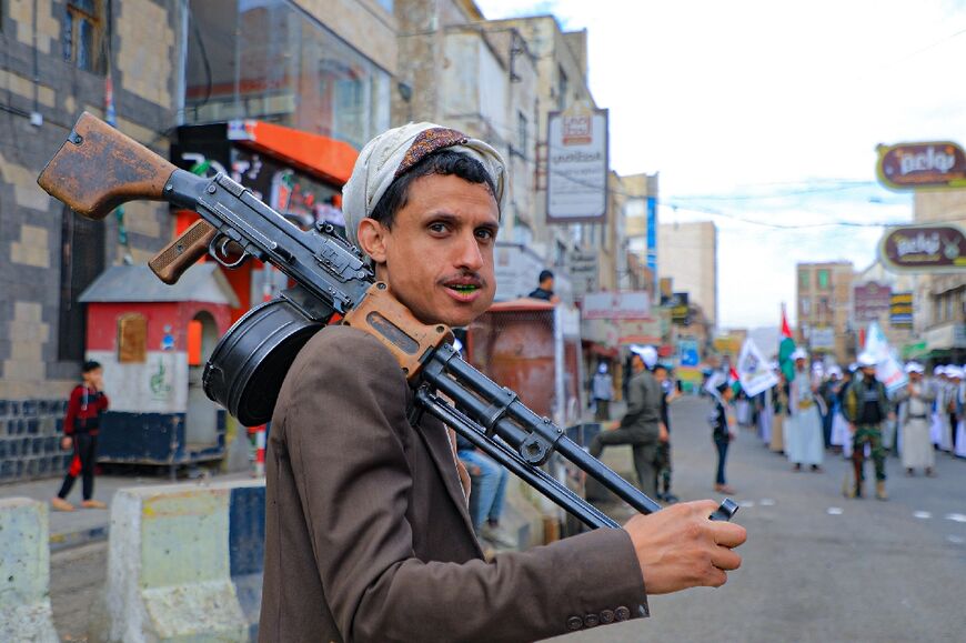 A supporter of Yemen's Huthi movement carries a weapon as he takes part in a pro-Palestinian rally in Sanaa on February 8, 2024