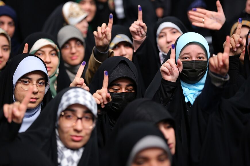 Young Iranian women eligible to vote for the first time show ink-stained fingers in a picture provided by the office of Iran's Supreme Leader Ayatollah Ali Khamenei