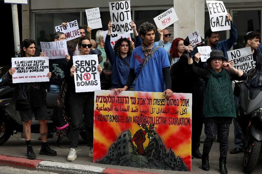 Demonstrators rally in front of the US Embassy Branch Office in Tel Aviv in an anti-war protest