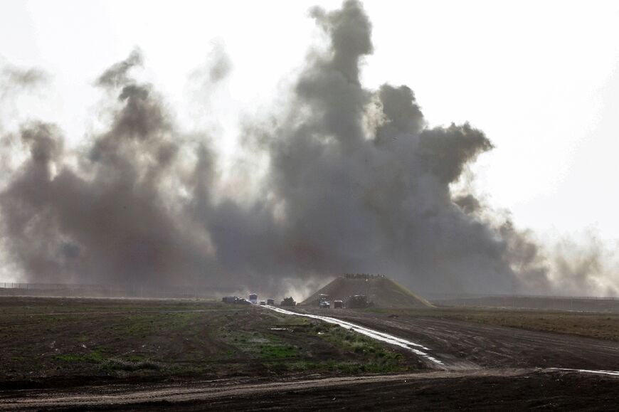 Seen from southern Israel, smoke billows inside Gaza as Israeli troops gather at the border 