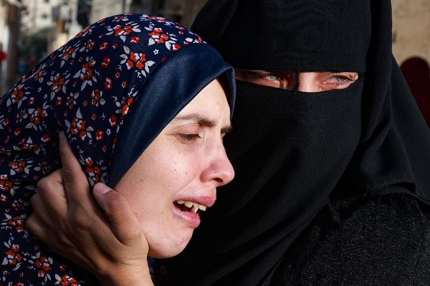 Gaza woman Rania Abu Anza (L), the mother of twins Naeem and Wissam who were killed in an overnight Israeli strike