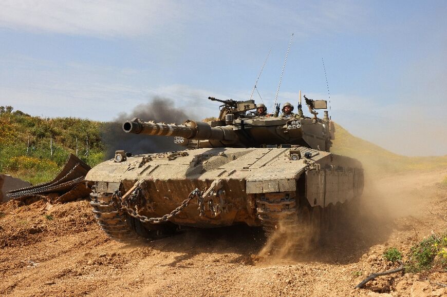 An Israeli tank moving along the border with the Gaza Strip amid the ongoing conflict between Israel and the militant group Hamas