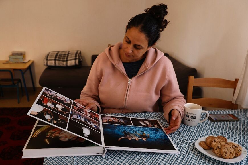 Bibas's sister-in-law, Ofri Bibas Levi, looks at a family photo album