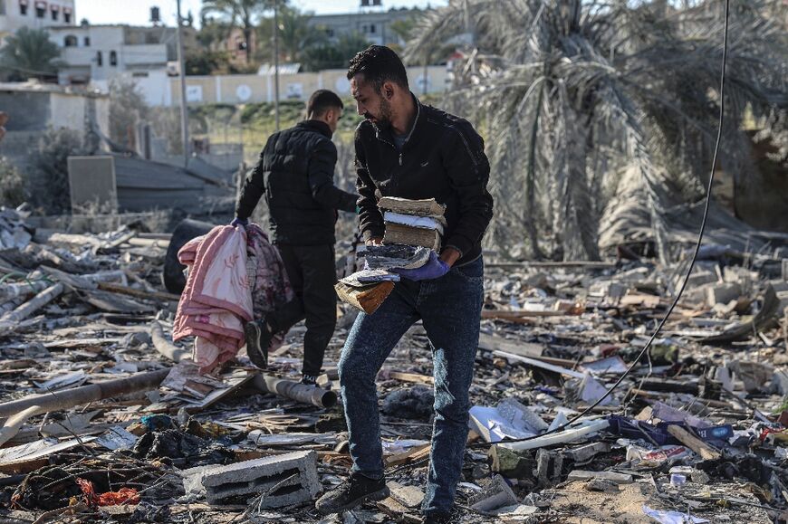 Palestinians search for belongings among the rubble of houses destroyed by Israeli bombing in Rafah, where around 1.5 million people have sought refuge