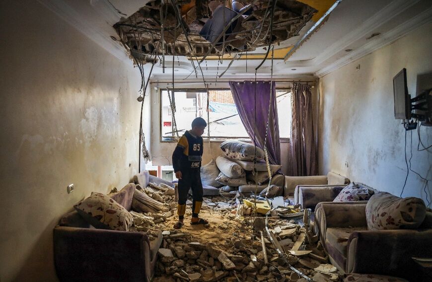 A Palestinian child in the living room of a building damaged during Israeli bombardment in Rafah, southern Gaza, where around 1.4 million Palestinians have tried to find refuge from the fighting