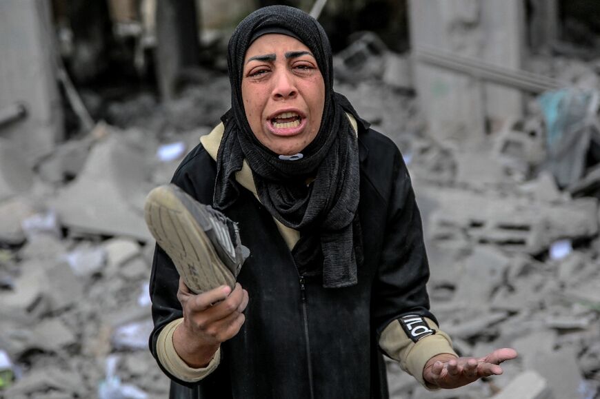 A woman in the aftermath of an Israeli bombardment in Gaza City, which continues to be hit more than five months into the war
