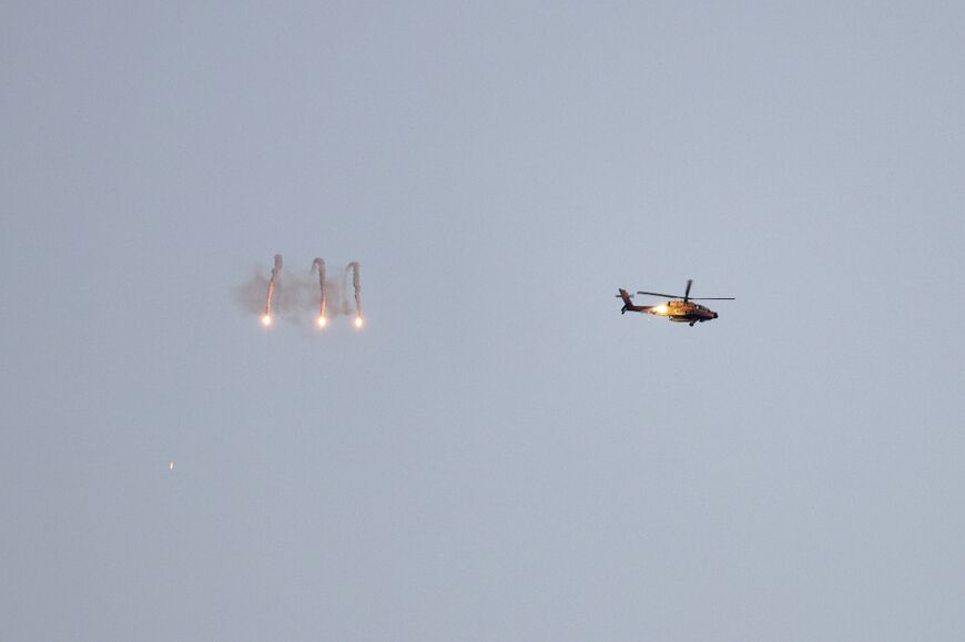 An Israeli army helicopter fires flares above the Gaza Strip 