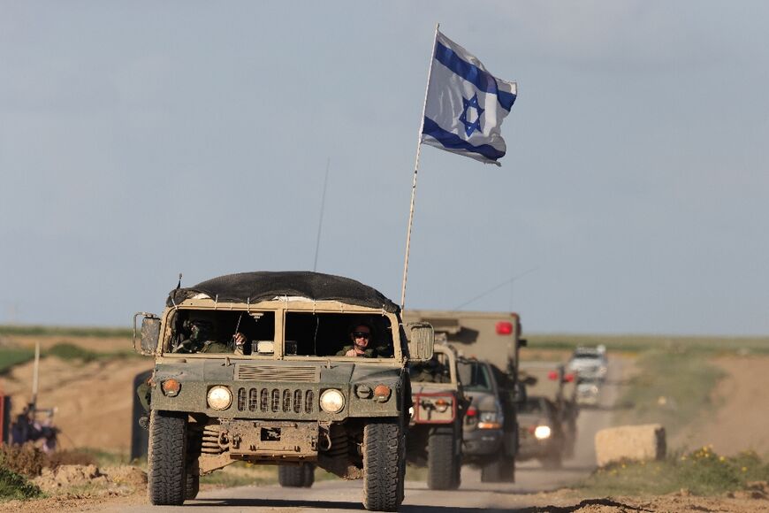 Seen from southern Israel, Israeli armoured personnel carriers leave Gaza