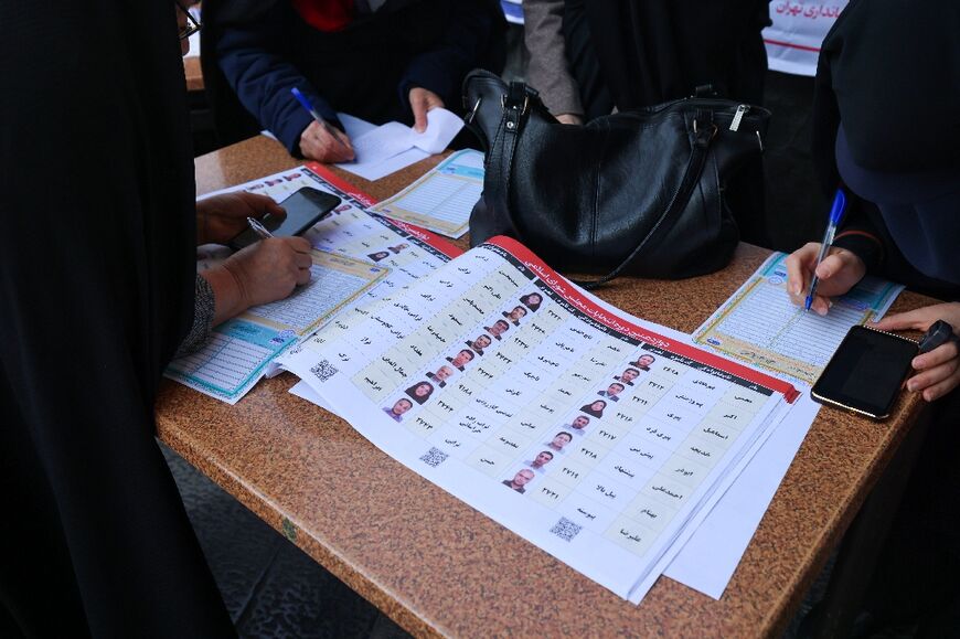 Iranian women fill out their ballots -- analysts expect conservatives and ultra-conservatives to dominate parliament once again
