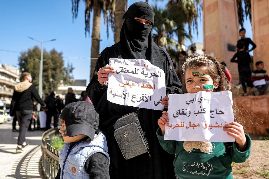 With her husband behind bars, Noha al-Atrash and her children joined a rally condemning torture and demanding prisoners' release