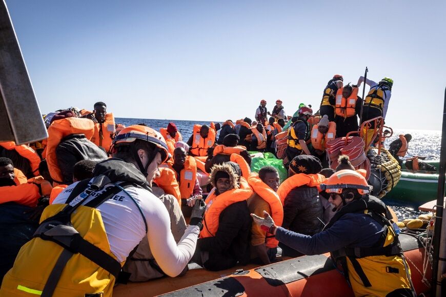 This photo taken on March 13, 2024 by international humanitarian organization SOS Mediterranee shows a miggrant rescue operation by the Ocean Viking vessel in the Libyan search and rescue region in international waters