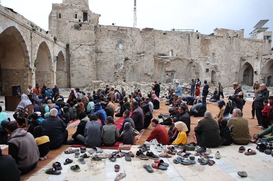 Palestinians pray in the courtyard of Gaza City's historic Omari Mosque, which has been heavily damaged by Israeli bombardment