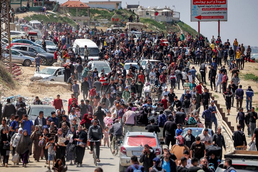 Displaced Palestinians take Gaza's coastal Rashid road to return to Gaza City as they pass through Nuseirat in the central Gaza Strip on April 14, 2024 