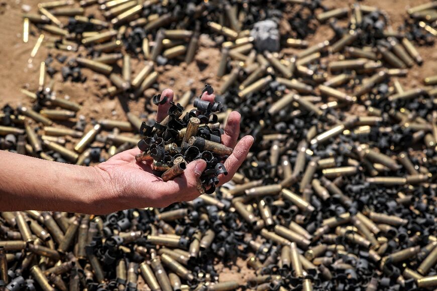 A person holds a handful of spent bullet casings in Khan Yunis on April 7, 2024 after Israel pulled its ground forces out of the southern Gaza Strip