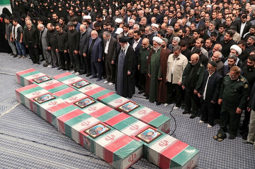Iran's supreme leader Ayatollah Ali Khamenei prays over the coffins of the seven Revolutionary Guards killed in a strike blamed on Israel in Syria