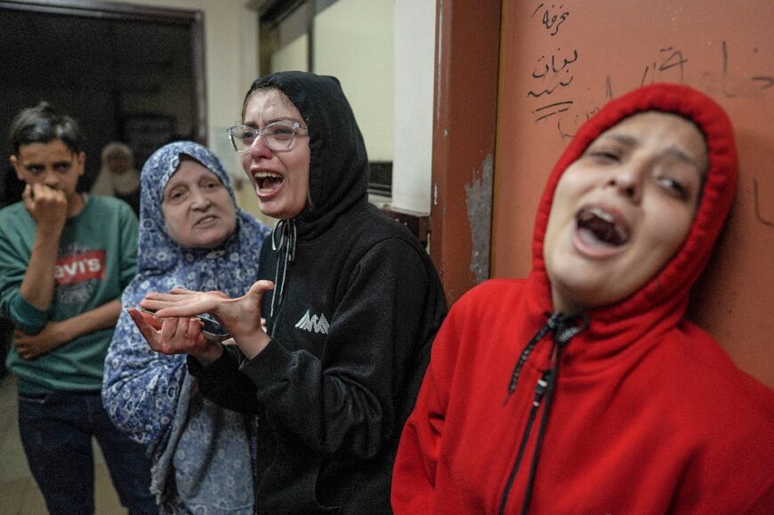 Relatives of the wounded react after an Israeli strike hit central Gaza, doctors at Al-Aqsa Hospital in the Gaza city of Deir El Balah said