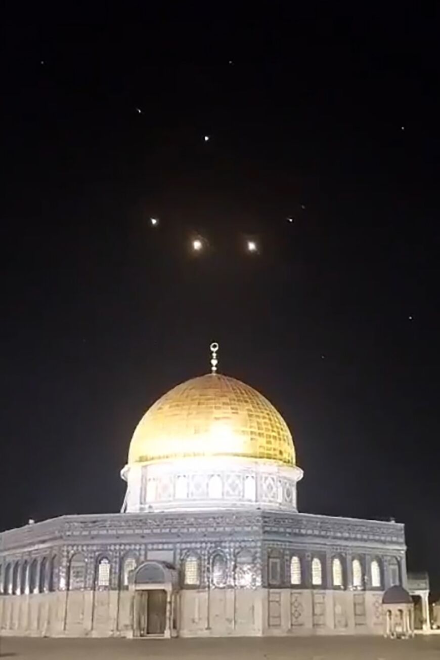 An image-grab from a video  taken from the Al-Aqsa mosque compound shows rocket trails in the sky above Jerusalem