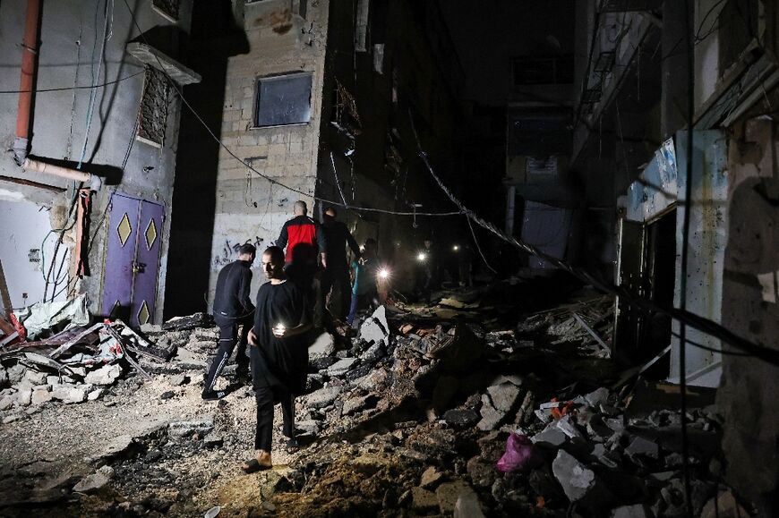 Palestinians inspect the damage following a deadly Israeli raid on the Nur Shams refugee camp in the occupied West Bank