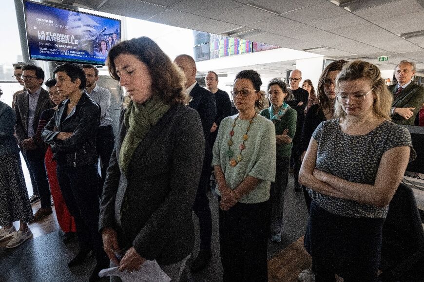 Agence France-Presse journalists hold a minute's silence to mark the anniversary of the death of their colleague Arman Soldin