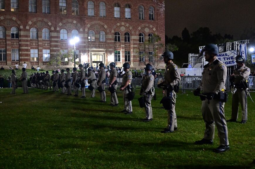 Police officers stand guard on the grounds of UCLA campus in Los Angeles where clashes broke out between pro-Palestinian demonstrators and counter-protestors
