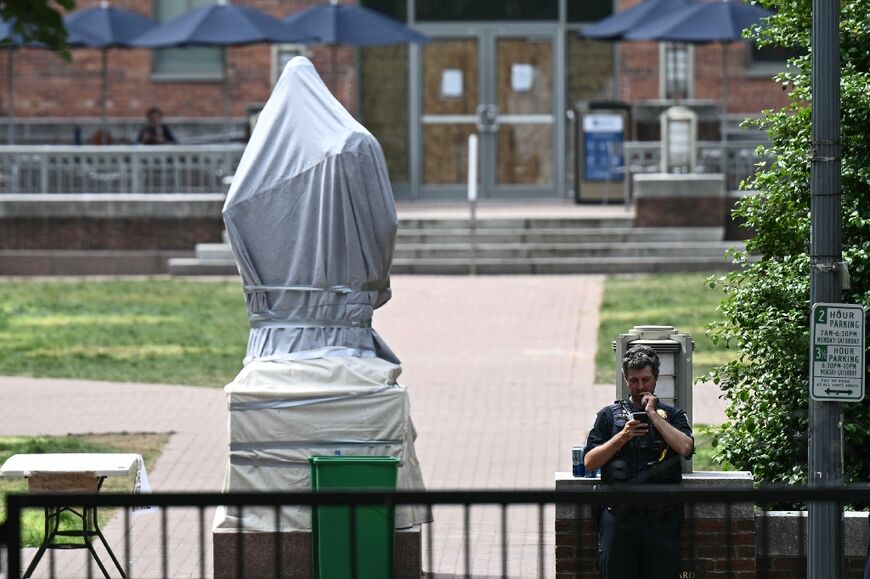 A statue of George Washington is covered up after police officers cleared a pro-Palestinian student protest encampment at George Washington University on May 8, 2024, in Washington